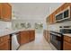 Charming kitchen features wood cabinetry, stainless appliances, and tile flooring at 3326 Sassaquin Ct, Orlando, FL 32818