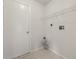 Functional laundry room with tile floors, door, wire shelving, and hookups at 3326 Sassaquin Ct, Orlando, FL 32818