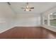 Open living room boasts wood flooring, ceiling fan, and generous sunlight throughout at 3326 Sassaquin Ct, Orlando, FL 32818