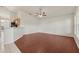 Open living room with ceiling fan, hardwood flooring, and a breakfast bar looking into the kitchen at 3326 Sassaquin Ct, Orlando, FL 32818