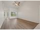 Inviting living room featuring wood-look floors, neutral walls, and a ceiling fan at 3326 Sassaquin Ct, Orlando, FL 32818