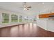 Bright living room featuring wood flooring, natural light, and adjacent kitchen access at 3326 Sassaquin Ct, Orlando, FL 32818