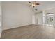 Open-plan living area with wood-look flooring, vaulted ceiling, and abundant natural light at 3326 Sassaquin Ct, Orlando, FL 32818