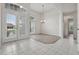 Bright, airy living room with tile and wood flooring, large windows, and high ceilings at 3326 Sassaquin Ct, Orlando, FL 32818