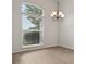 Light-filled living room featuring wood floors, a large arched window, and an elegant chandelier at 3326 Sassaquin Ct, Orlando, FL 32818