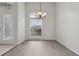 Spacious formal living room with high ceilings, gray laminate floors, and an elegant chandelier at 3326 Sassaquin Ct, Orlando, FL 32818