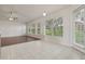 Bright living room boasts lots of natural light, ceiling fan, and seamless transition from tile to wood floors at 3326 Sassaquin Ct, Orlando, FL 32818