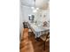 Dining room with hardwood floors and table set for four with elegant chandelier at 3379 S Kirkman Rd # 1027, Orlando, FL 32811