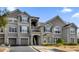 Exterior view of a condominium building with gray siding and arched windows at 3379 S Kirkman Rd # 1027, Orlando, FL 32811