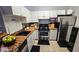 Efficient kitchen design with stainless steel appliances, white cabinetry, and granite countertops at 3379 S Kirkman Rd # 1027, Orlando, FL 32811