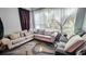 Cozy living room featuring a large corner sofa, patterned rug, and natural light from the window at 3379 S Kirkman Rd # 1027, Orlando, FL 32811