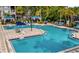 Community pool area with comfortable lounge chairs and cabanas, surrounded by lush landscaping at 3379 S Kirkman Rd # 1027, Orlando, FL 32811