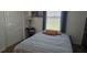 Cozy bedroom with a bedside table and lamp providing soft lighting with window at 35 Olive Cir, Ocala, FL 34472