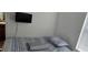 Well-lit bedroom with a comfortable bed and a mounted flat-screen television at 35 Olive Cir, Ocala, FL 34472