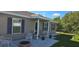 Close-up of the front porch, showcasing stylish outdoor seating and decorative plants at 35 Olive Cir, Ocala, FL 34472