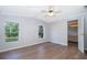 Bedroom with wood-look flooring and two windows, offering a light and airy atmosphere at 411 Racoon Trl, Geneva, FL 32732