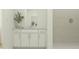 Modern bathroom featuring a sleek vanity, ample storage, and stylish tiled shower at 4335 Curacao Pl, Kissimmee, FL 34758