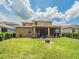 Lush backyard features a screened lanai, mature trees, and green grass at 461 Brunswick Dr, Davenport, FL 33837