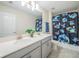 Bathroom featuring a double vanity, modern fixtures, and a 'Stitch' themed shower curtain at 461 Brunswick Dr, Davenport, FL 33837