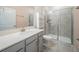 This bathroom features gray cabinetry, a white countertop, and a glass-enclosed shower at 461 Brunswick Dr, Davenport, FL 33837