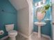 Charming powder room with a pedestal sink, patterned wallpaper, and modern fixtures at 461 Brunswick Dr, Davenport, FL 33837