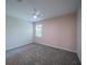 This bedroom features a window, carpet, and a ceiling fan at 461 Brunswick Dr, Davenport, FL 33837