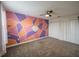 Bedroom with unique geometric accent wall, ceiling fan, and carpet for a cozy feel at 461 Brunswick Dr, Davenport, FL 33837