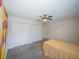 Bedroom featuring a colorful wall design, carpet floors, ceiling fan, and double door closet at 461 Brunswick Dr, Davenport, FL 33837