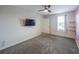 Well-lit bedroom with carpet, TV, and a window offering natural light and a view at 461 Brunswick Dr, Davenport, FL 33837