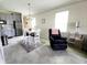 Bright dining room featuring an adjacent kitchen and a comfortable recliner at 461 Brunswick Dr, Davenport, FL 33837