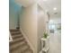 Inviting hallway with stairs leading to a bright, open living area, and neutral decor throughout at 461 Brunswick Dr, Davenport, FL 33837