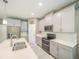 Modern kitchen features stainless steel appliances, gray cabinets, and a double oven for cooking at 461 Brunswick Dr, Davenport, FL 33837