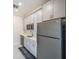 Kitchen features modern stainless steel appliances, light gray cabinets, and white countertops at 461 Brunswick Dr, Davenport, FL 33837