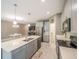 Bright kitchen features stainless steel appliances, gray cabinets, and sleek countertop island at 461 Brunswick Dr, Davenport, FL 33837