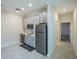 Kitchen features modern stainless steel appliances, tile flooring, and light gray cabinets at 461 Brunswick Dr, Davenport, FL 33837