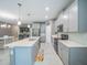 Bright, open kitchen with large island, stainless appliances, and sleek cabinets with ample counter space at 461 Brunswick Dr, Davenport, FL 33837