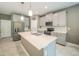 Stylish kitchen features stainless steel appliances, gray cabinets, and a bright white countertop island at 461 Brunswick Dr, Davenport, FL 33837