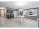 Open-concept kitchen features stainless steel appliances, a stylish backsplash, and an adjacent white island table at 461 Brunswick Dr, Davenport, FL 33837
