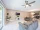 Spacious living room with tile floors, ceiling fan, and sliding doors leading to outdoor space at 461 Brunswick Dr, Davenport, FL 33837
