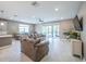 Bright, open living room showcasing tile floors, recessed lighting, and comfortable seating arrangements at 461 Brunswick Dr, Davenport, FL 33837