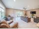 Cozy living room boasts tile floors, comfortable seating, and sliding glass doors to patio at 461 Brunswick Dr, Davenport, FL 33837