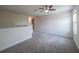 Spacious upstairs loft area with carpeting, a ceiling fan, and plenty of room to relax and play at 461 Brunswick Dr, Davenport, FL 33837