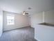 Upstairs loft space with a ceiling fan and lots of natural light from the large window at 461 Brunswick Dr, Davenport, FL 33837