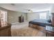 Spacious main bedroom featuring a ceiling fan, neutral carpet, and a view of the en-suite bathroom at 461 Brunswick Dr, Davenport, FL 33837