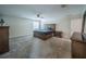 Spacious main bedroom with carpeting, a ceiling fan, and plenty of natural light from the large window at 461 Brunswick Dr, Davenport, FL 33837