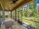 Enjoy outdoor living on this screened-in patio overlooking a landscaped yard with a ceiling fan at 461 Brunswick Dr, Davenport, FL 33837