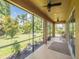 Large screened-in patio, complete with ceiling fans and views of the spacious, lush backyard at 461 Brunswick Dr, Davenport, FL 33837
