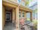 Covered porch features stone accents, a tile floor, and a view of the landscaped front yard at 461 Brunswick Dr, Davenport, FL 33837
