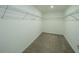 Walk-in closet with carpet and white wire shelving, offering ample storage and organization space at 461 Brunswick Dr, Davenport, FL 33837