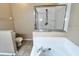 Bright bathroom features a glass-enclosed shower, soaking tub, and neutral tile at 500 Wellesly St, Oviedo, FL 32765